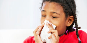 Child Blowing Nose into tissue